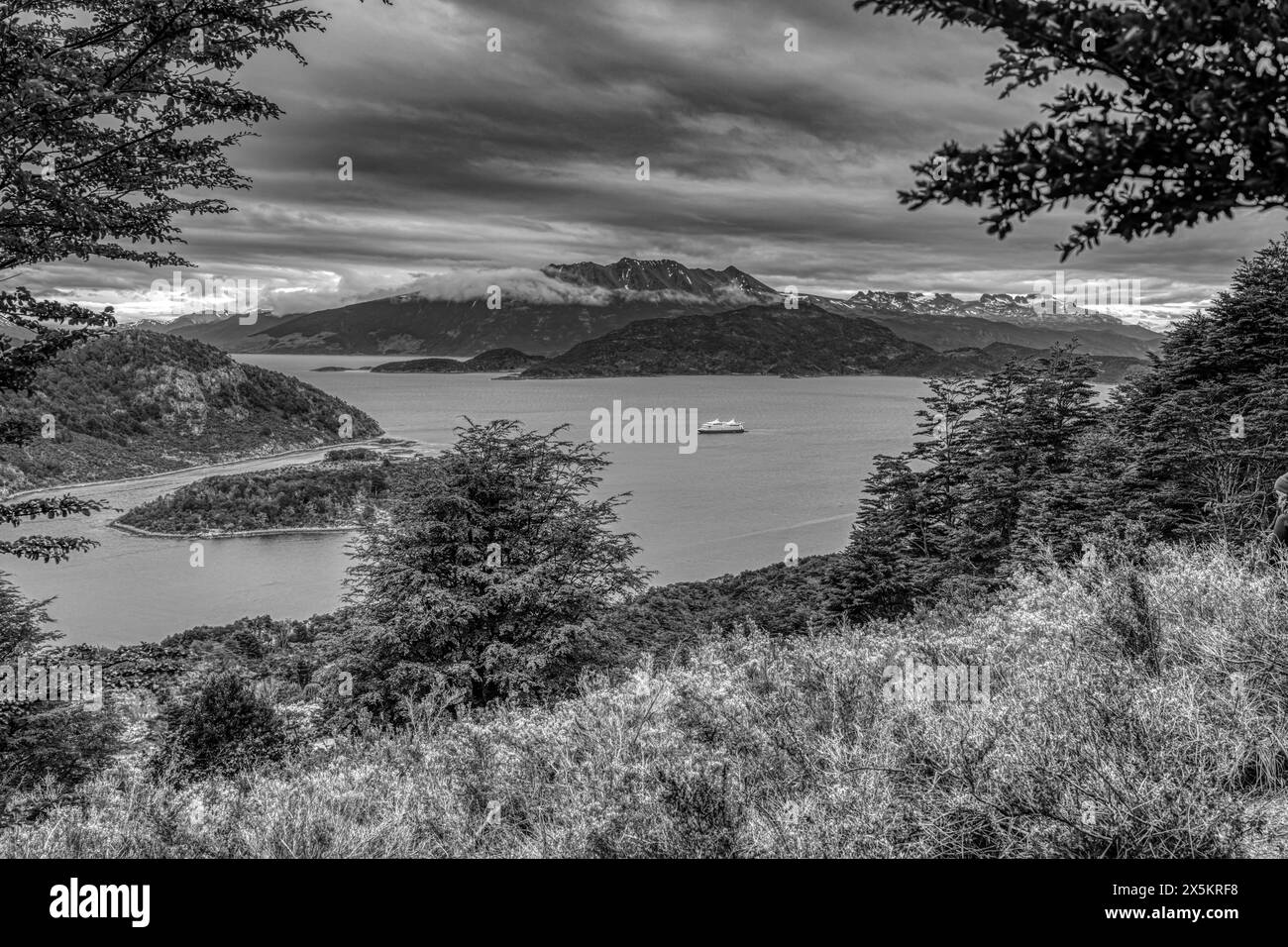 Argentina, Tierra del Fuego National Park. Black and white panoramic of tourist boat in Wailua Bay. Stock Photo