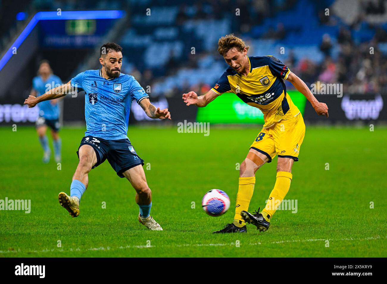 10th May 2024; Allianz Stadium, Sydney, NSW, Australia: A-League Football, Finals Series, Semi Final, First Leg, Sydney FC versus Central Coast Mariners; Jacob Farrell of the Central Coast Mariners clears the ball under pressure from Anthony Caceres of Sydney FC Stock Photo