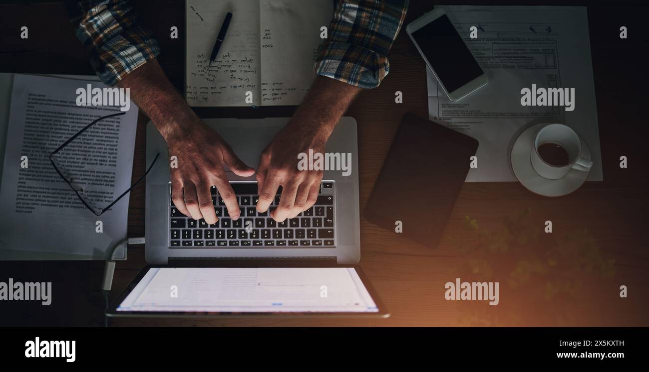 Businessman, programmer and typing on laptop in office with paperwork for data analytics, coding and software script. Top view, tech expert and Stock Photo