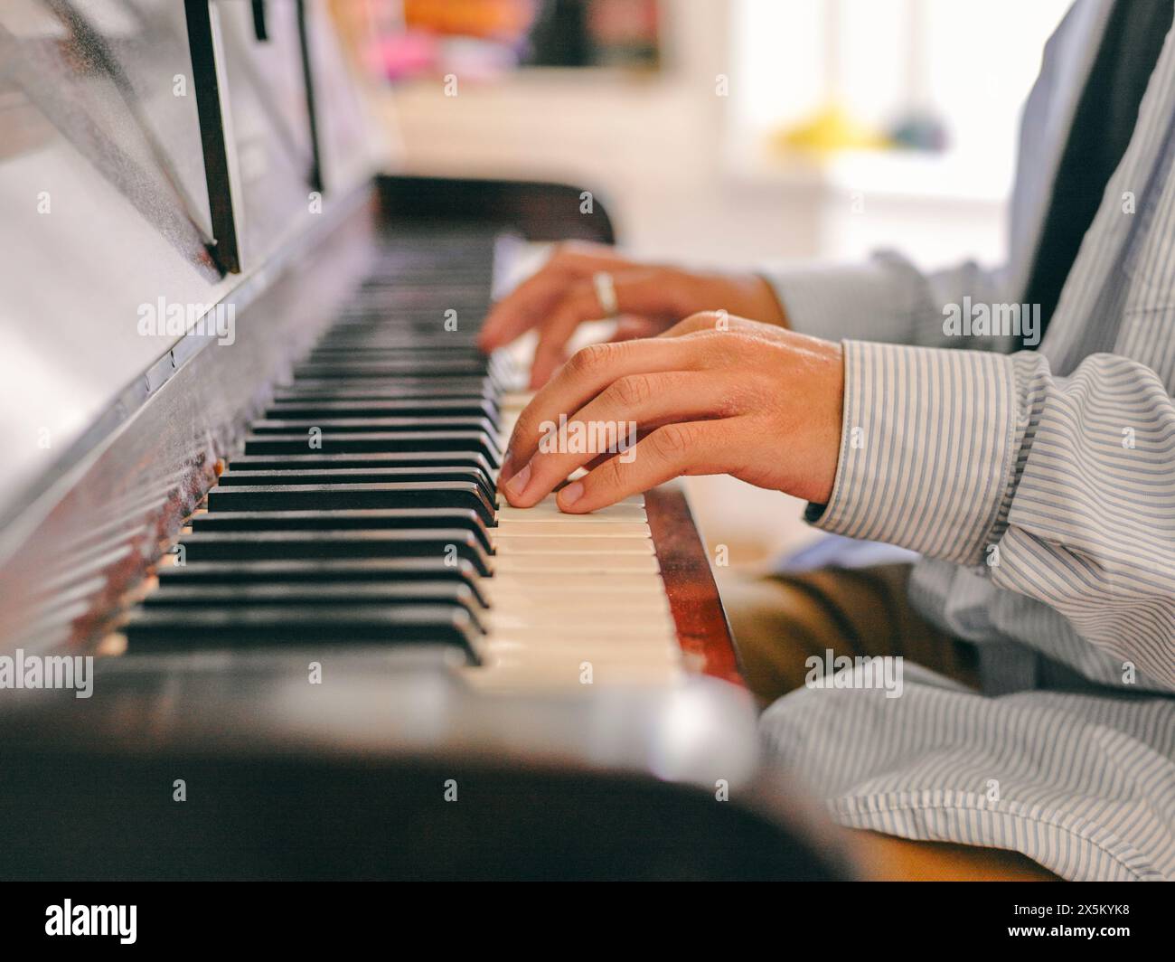 Boy playing piano Stock Photo