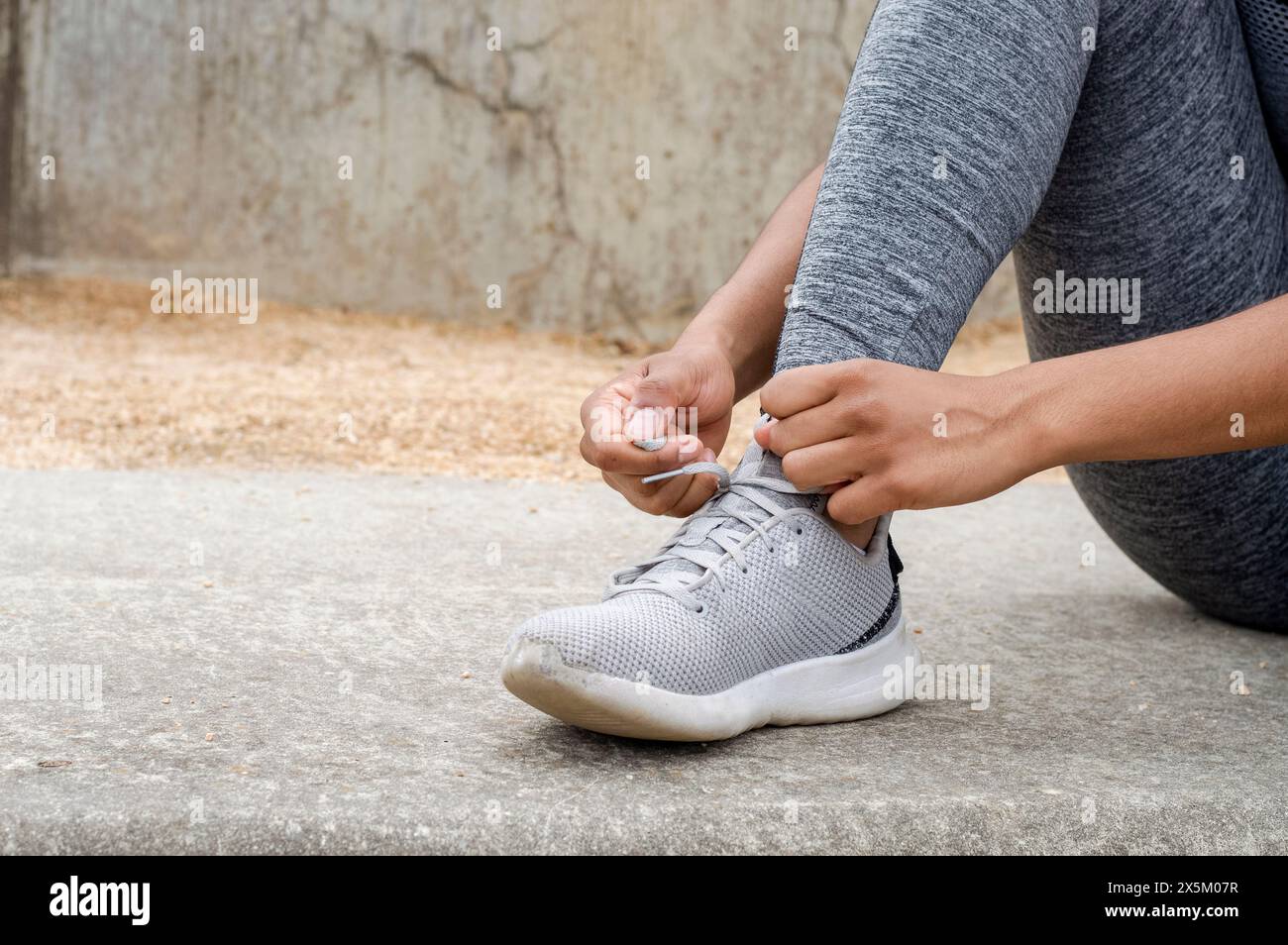 Close up of woman tying laces in sports shoes before training Stock Photo