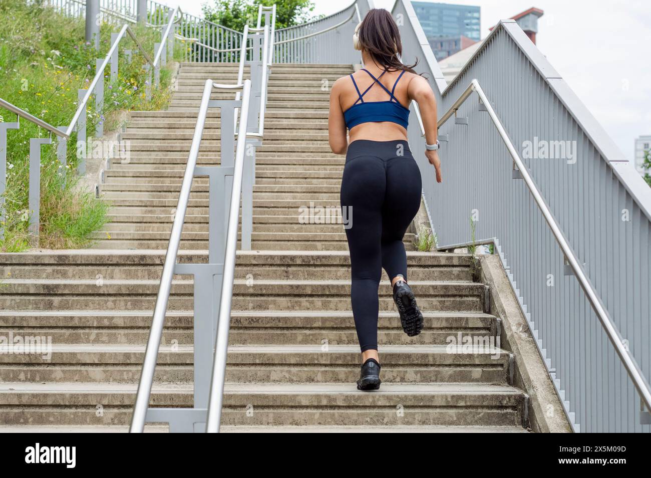 Black woman running up stairs hi-res stock photography and images - Alamy