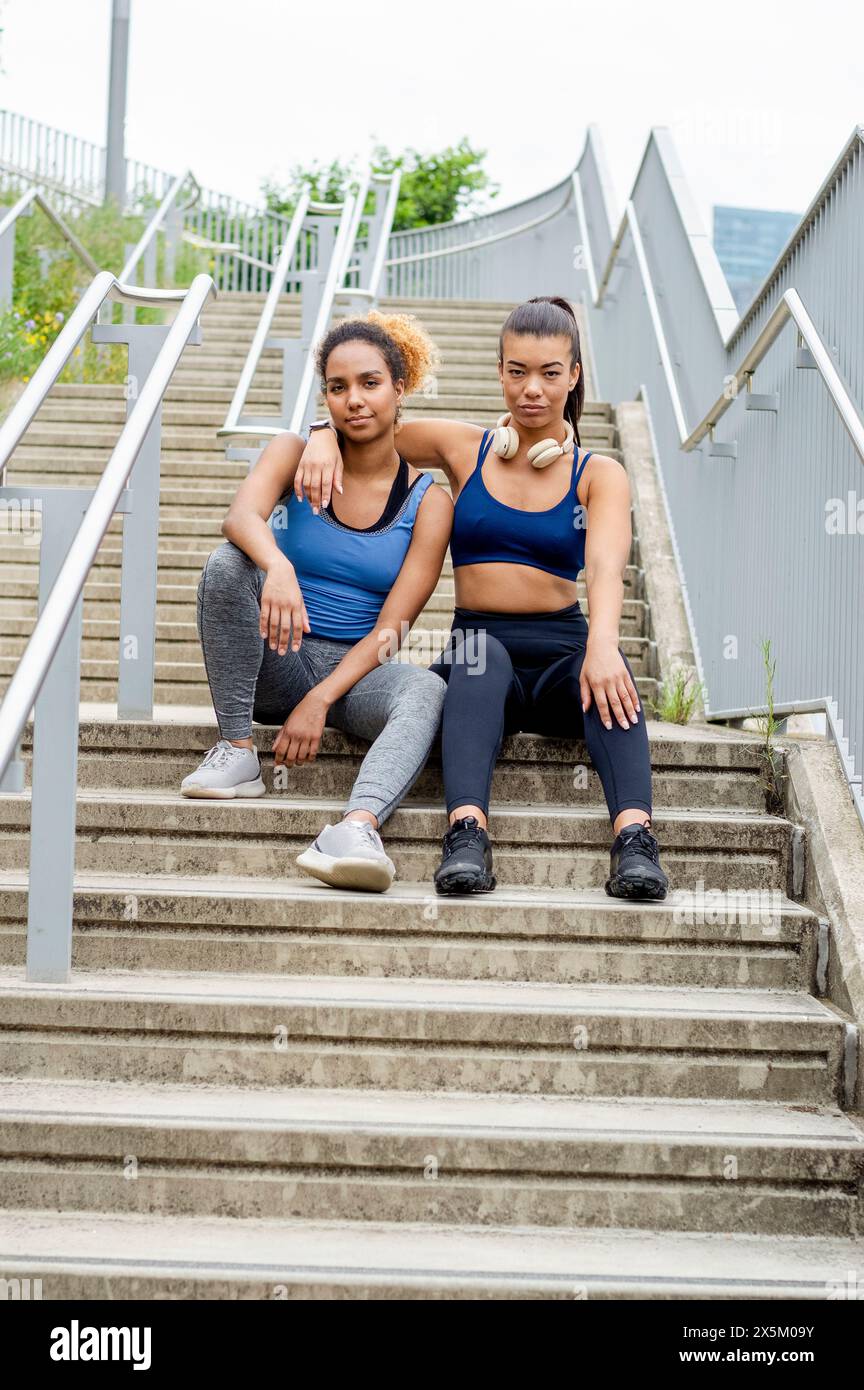 Two people sitting on stairs hi-res stock photography and images - Alamy