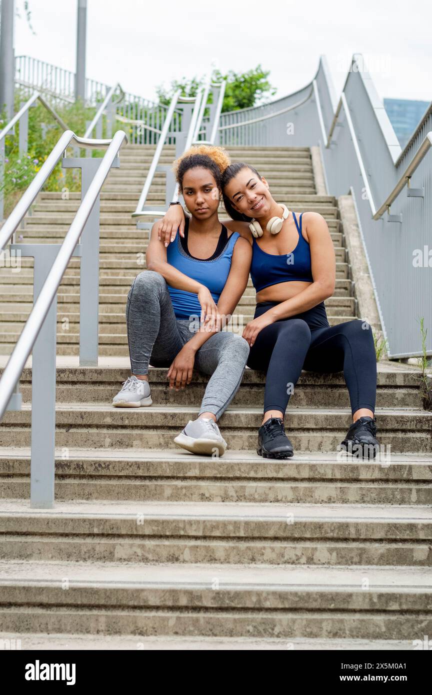 Two people sitting on stairs hi-res stock photography and images - Alamy