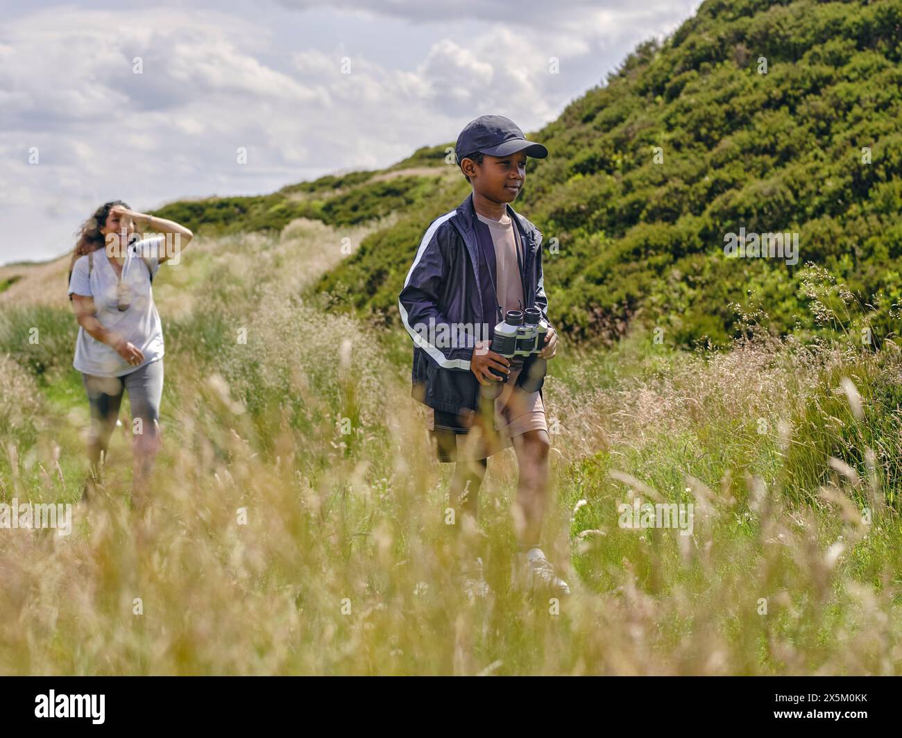 Mother with son hiking in hills Stock Photo