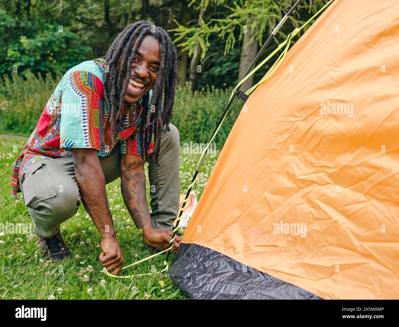 Man setting up tent Stock Photo