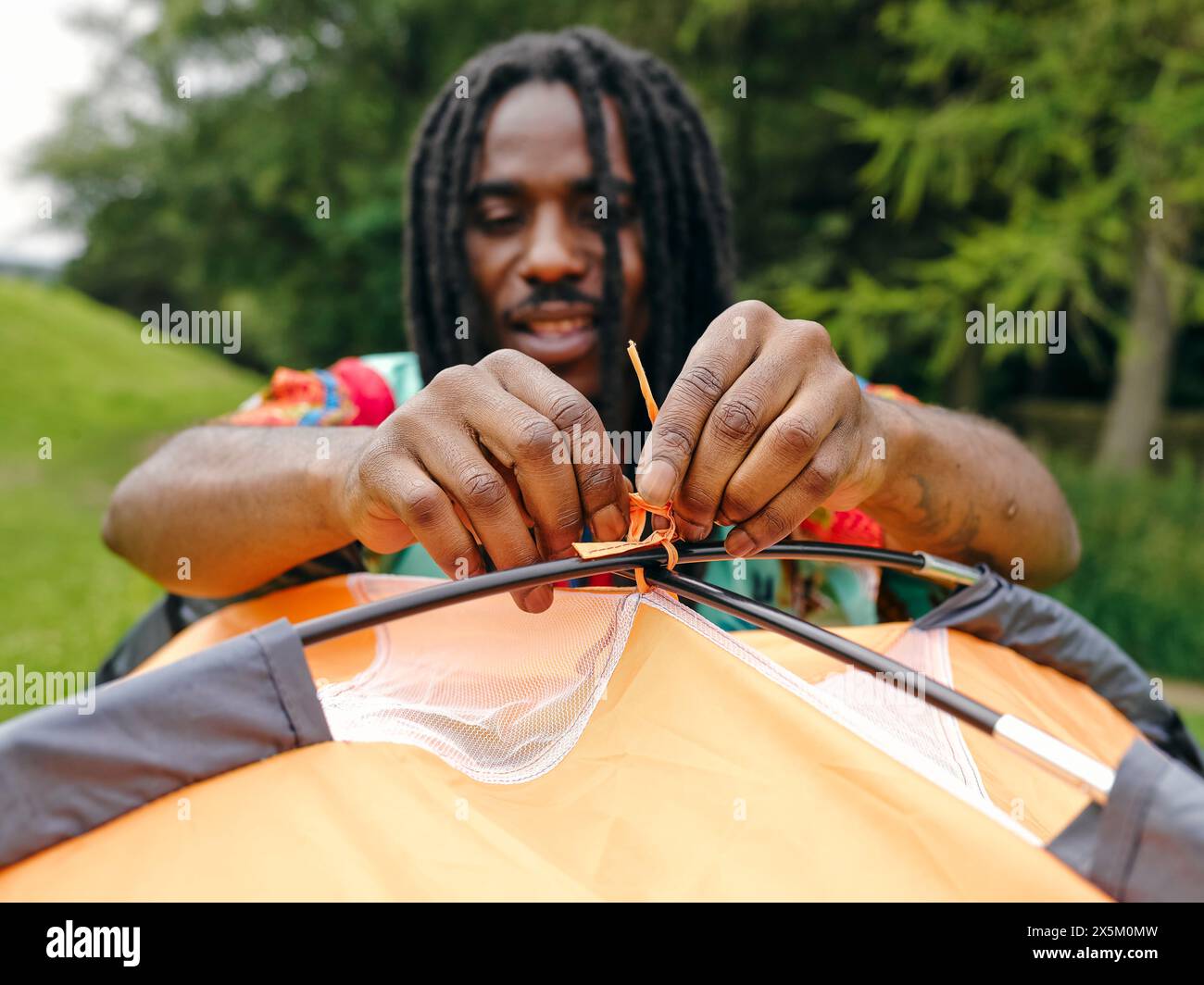 Man setting up tent Stock Photo