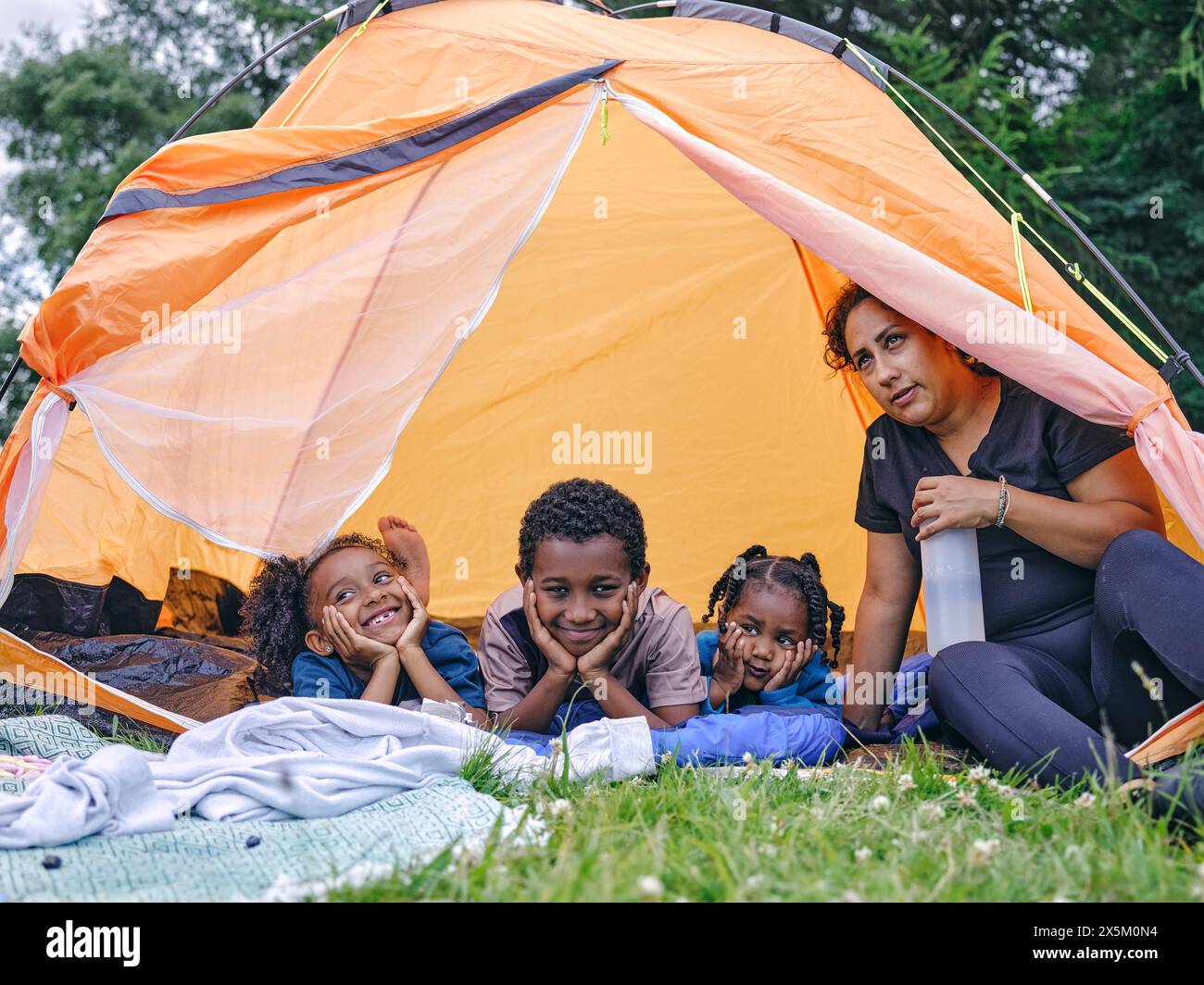 Mother and children in tent Stock Photo - Alamy