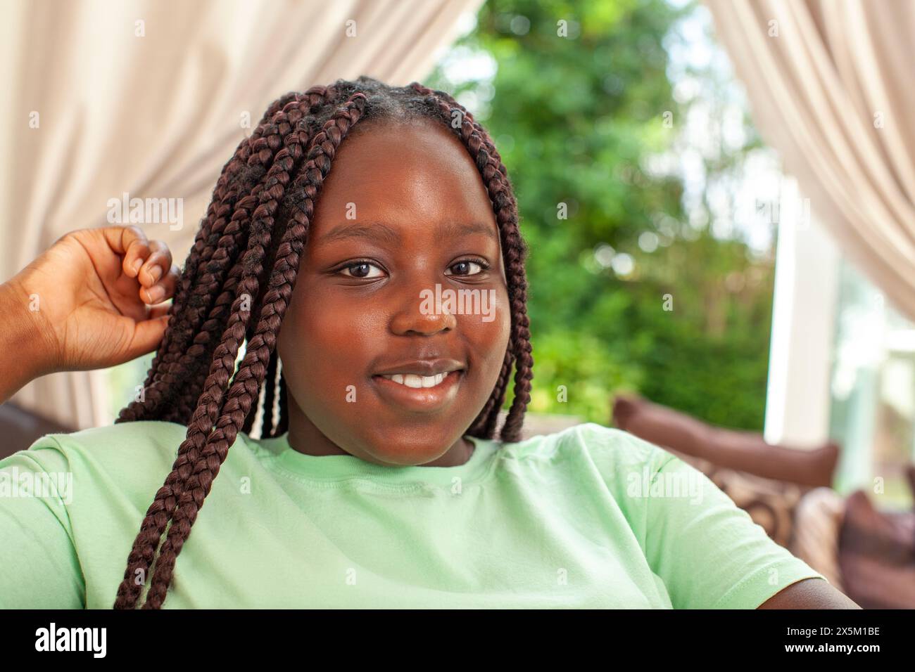Portrait of smiling girl with braided hair Stock Photo - Alamy