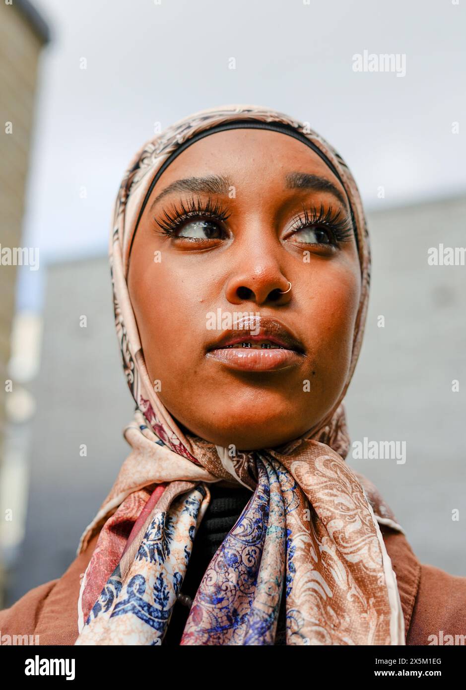 UK, London, Portrait of young woman wearing hijab outdoors Stock Photo