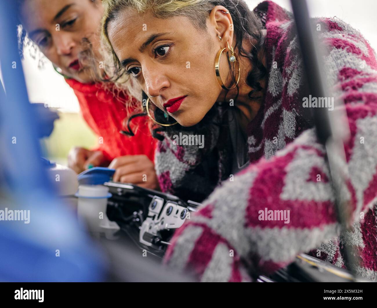 Women fixing broken car Stock Photo