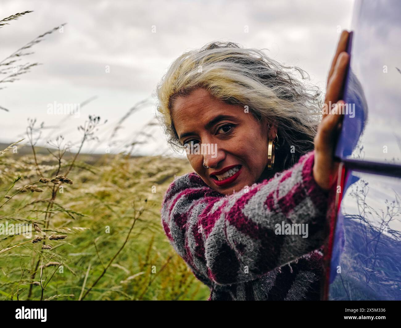 Woman pushing broken car Stock Photo