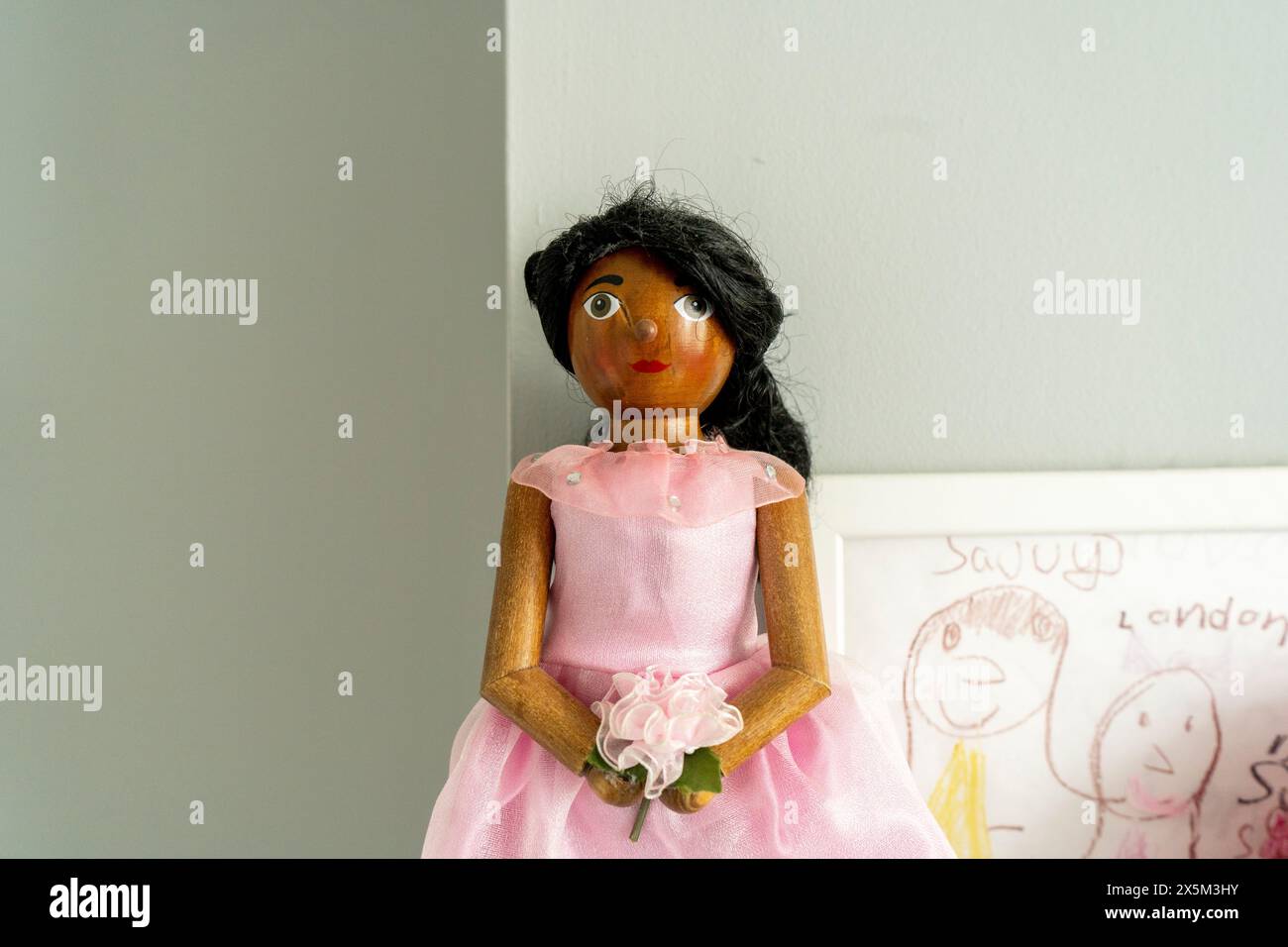 Wooden doll in pink dress Stock Photo