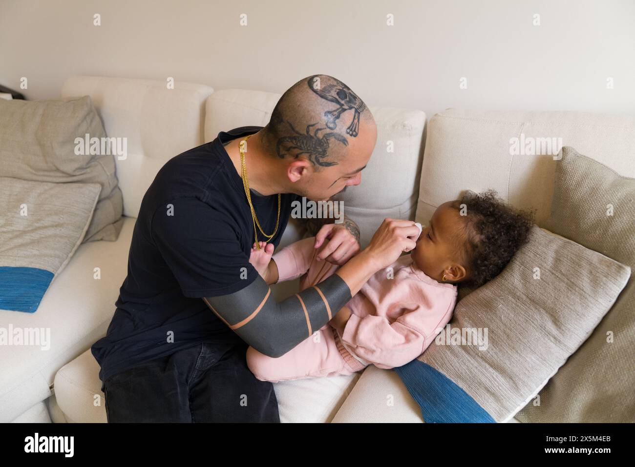 Father helping daughter blow nose Stock Photo - Alamy