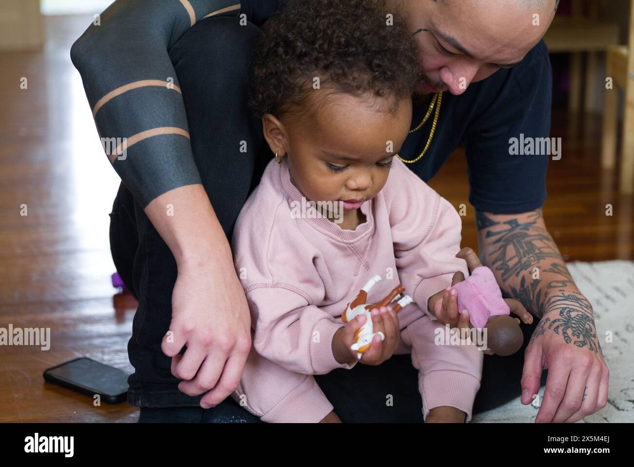 Father playing with daughter at home Stock Photo