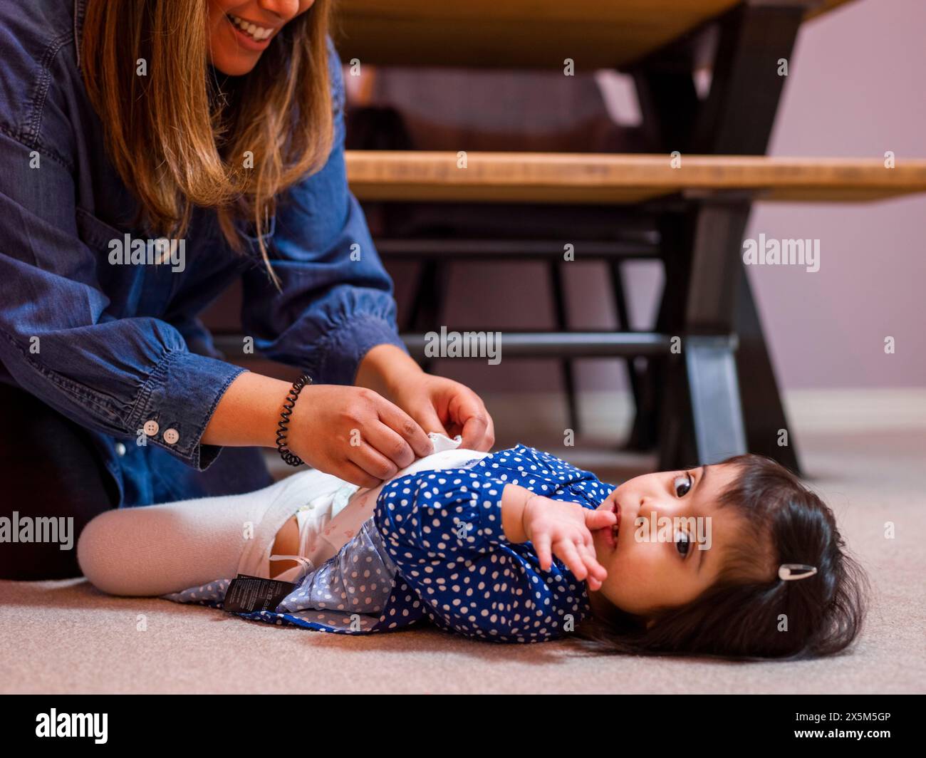 Mother caring for daughter with feeding tube Stock Photo
