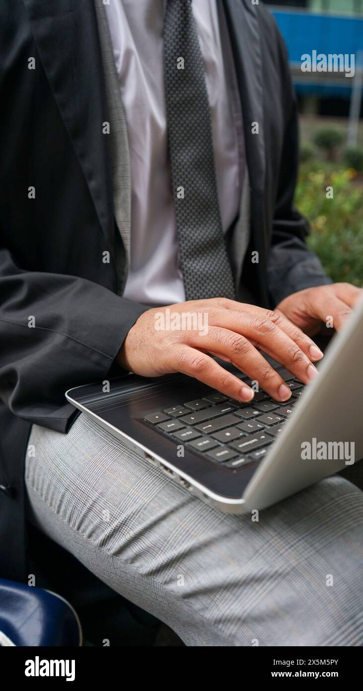 Midsection of business man using laptop Stock Photo