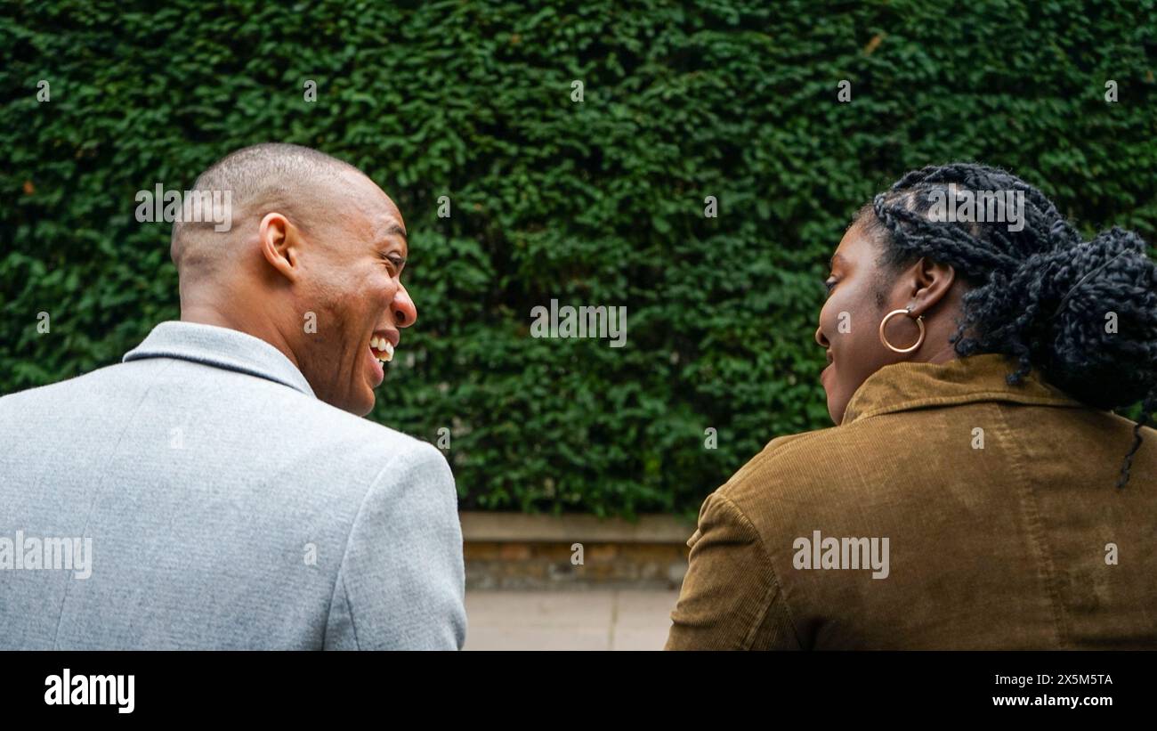 Two women and man talking rear view hi-res stock photography and images ...