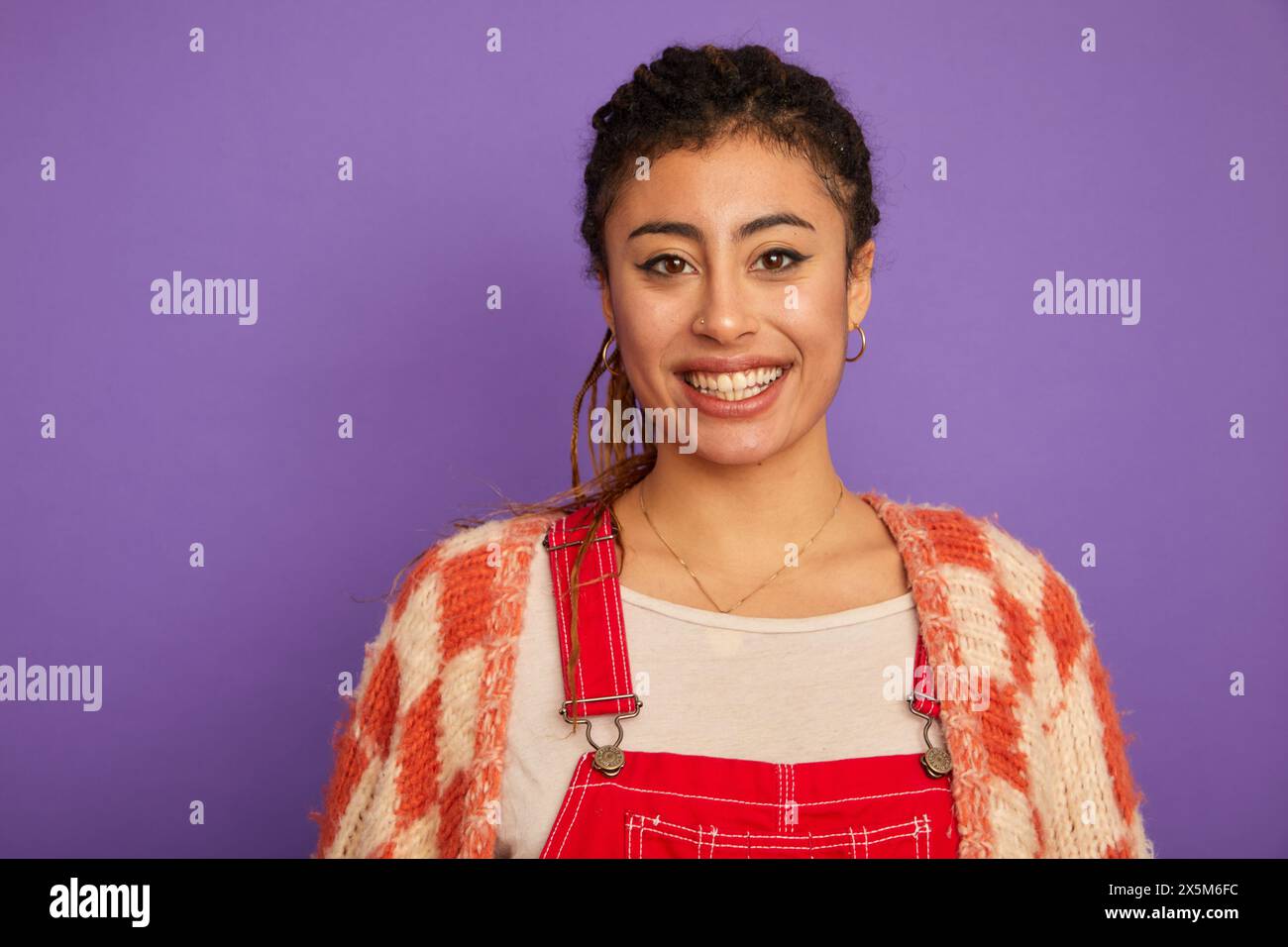 Studio portrait of smiling woman against purple background Stock Photo ...