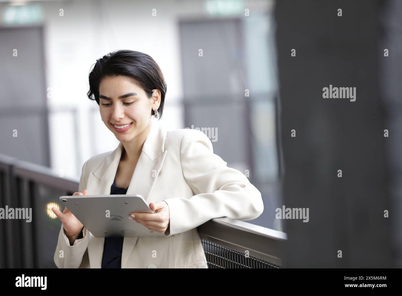 Smiling businesswoman using tablet Stock Photo
