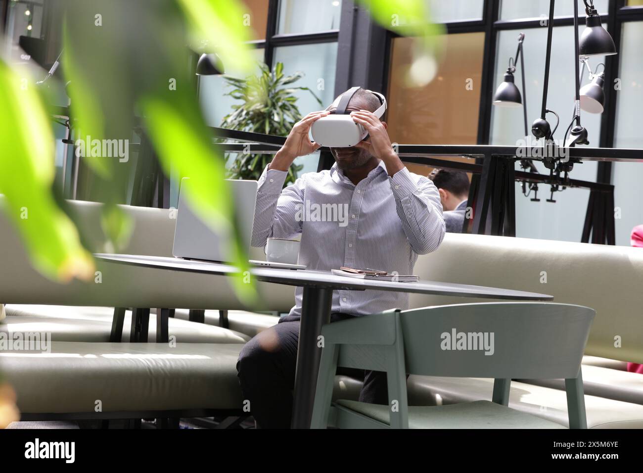 Businessman putting on virtual reality headset Stock Photo