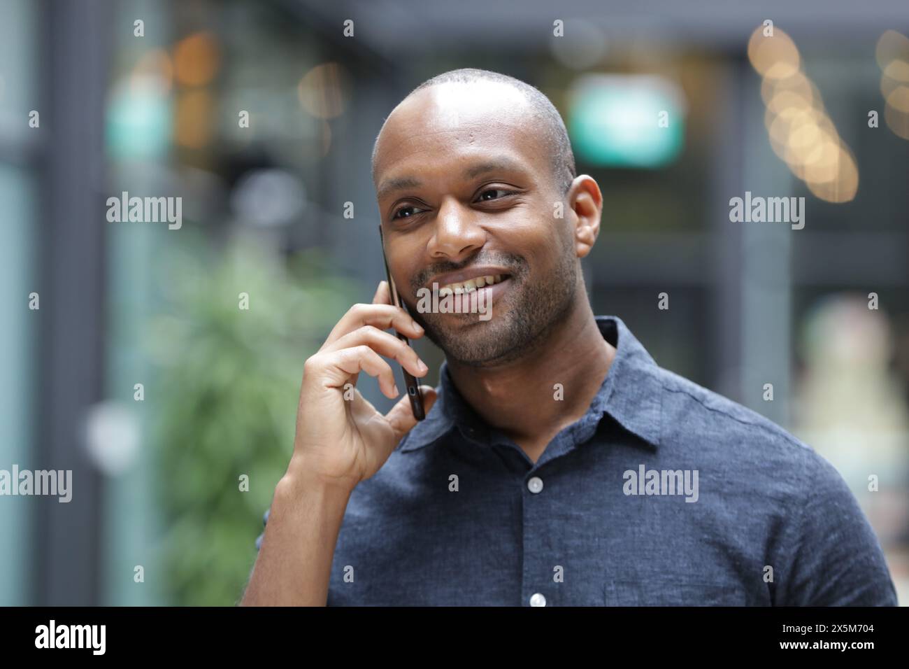 Smiling businessman talking on phone Stock Photo