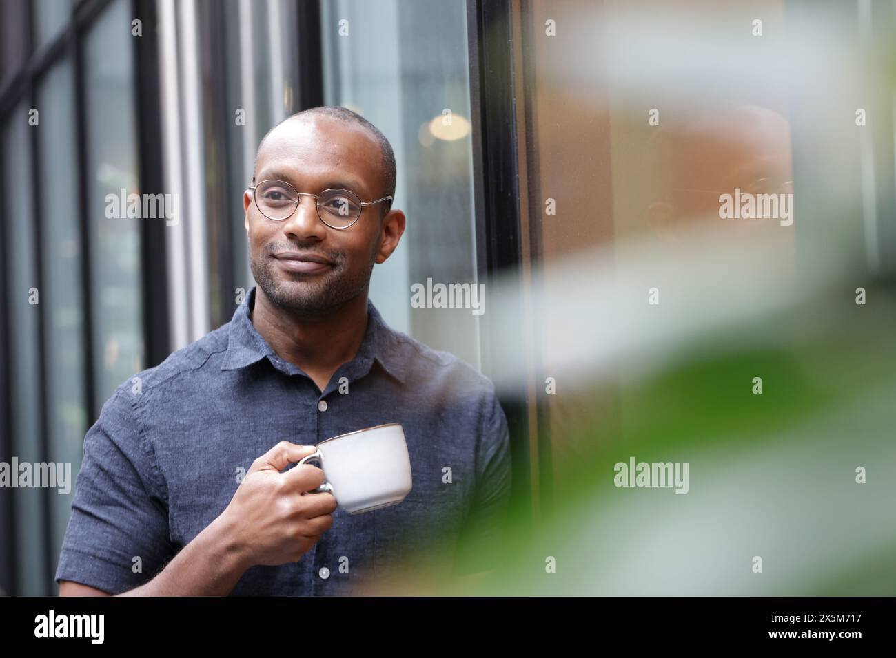 Businessman having coffee break in office Stock Photo