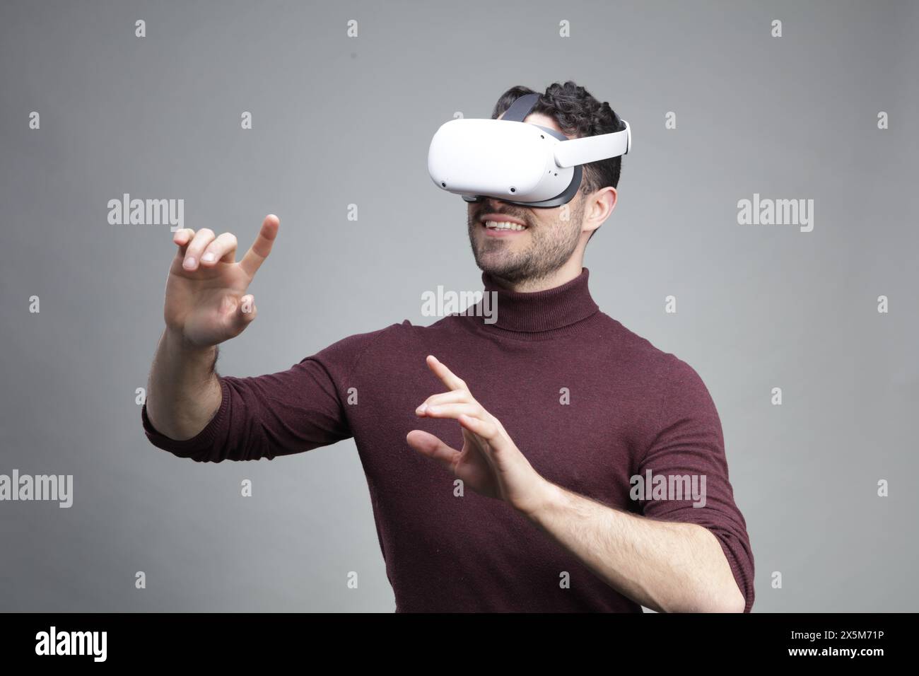 Young man wearing virtual reality headset and gesturing Stock Photo