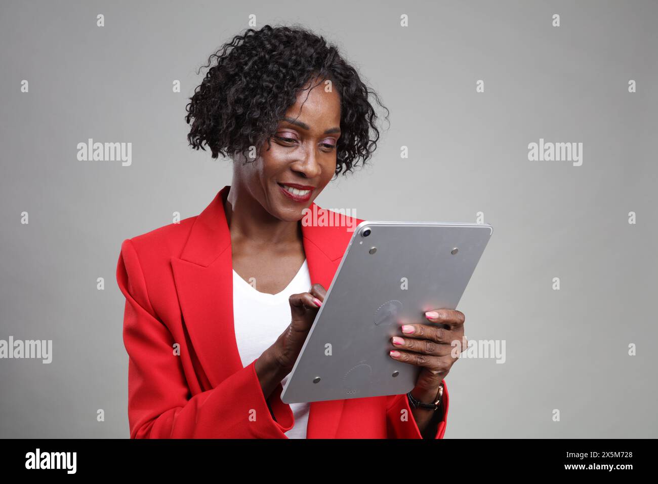 Smiling businesswoman using tablet Stock Photo