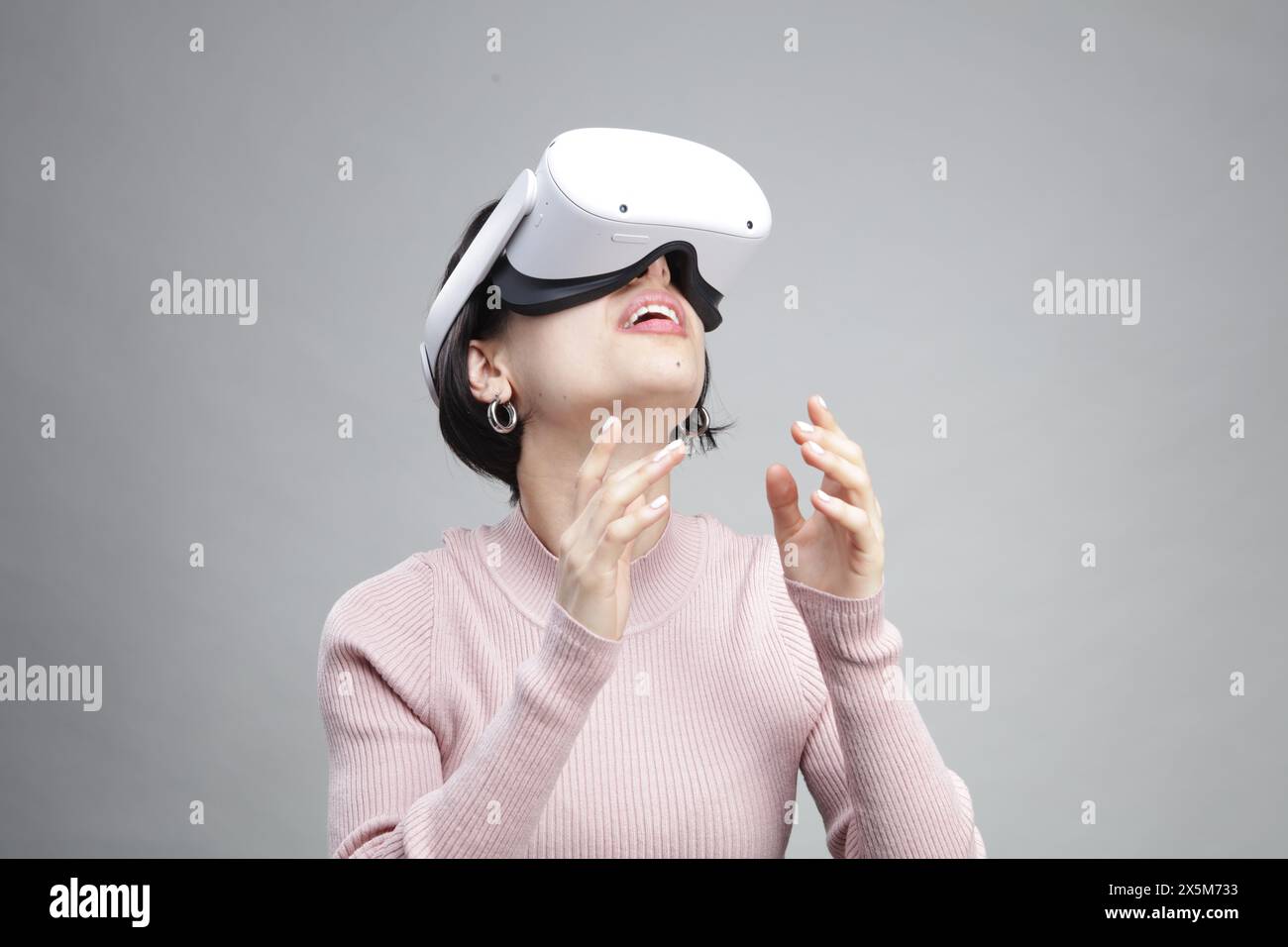 Young woman using virtual reality headset Stock Photo