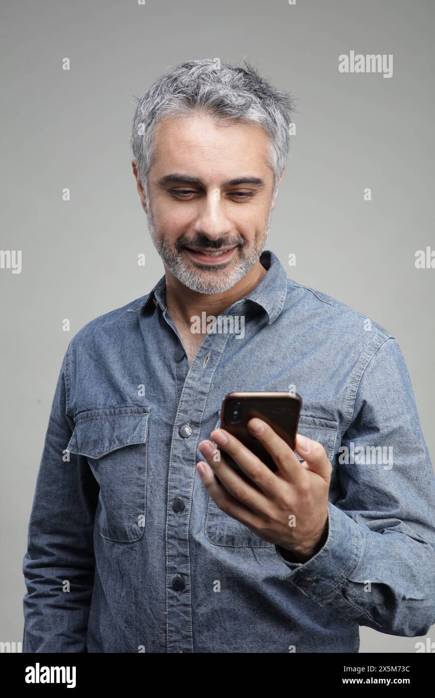 Mature man using smart phone Stock Photo