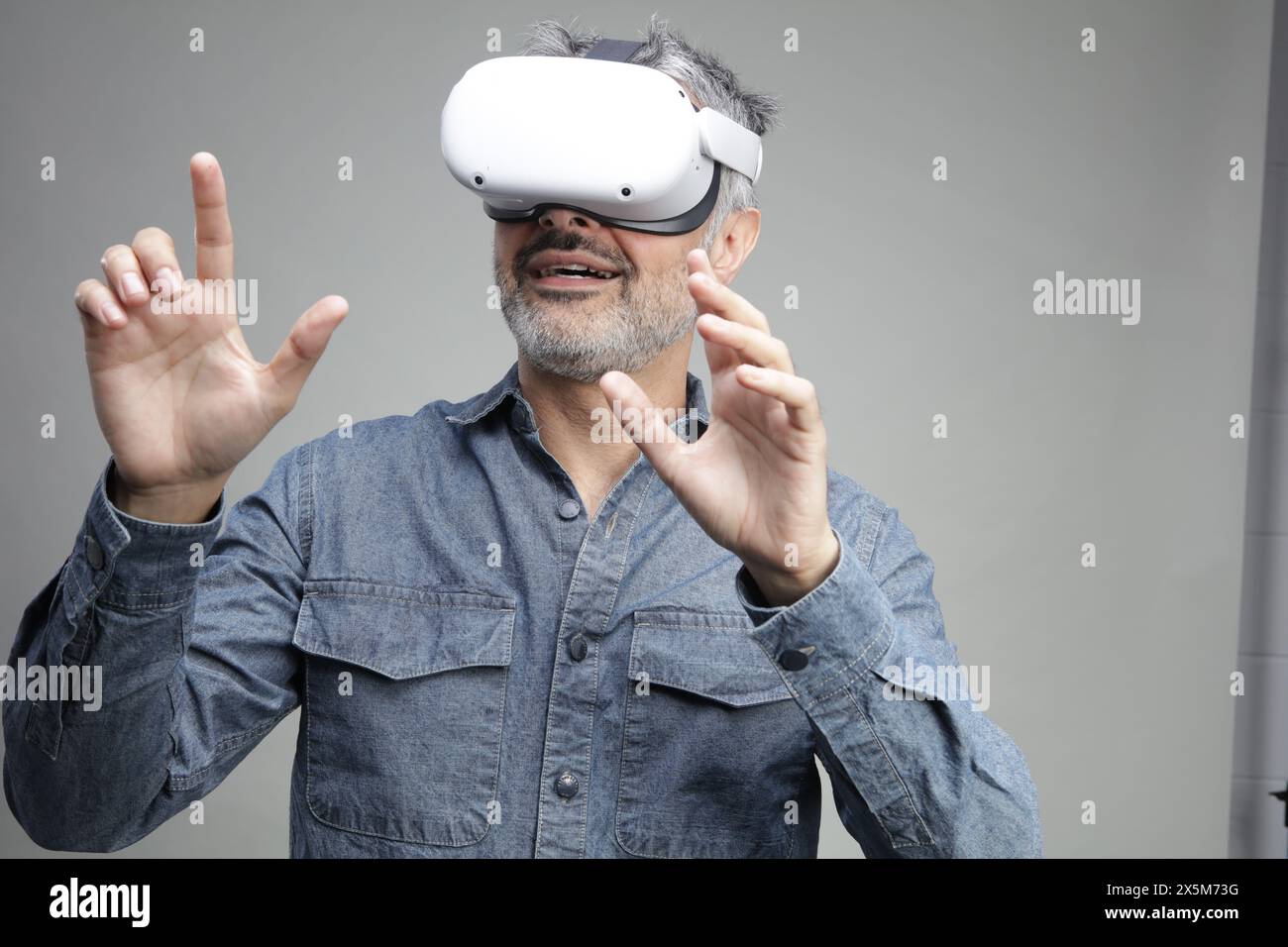 Mature man using virtual reality headset Stock Photo