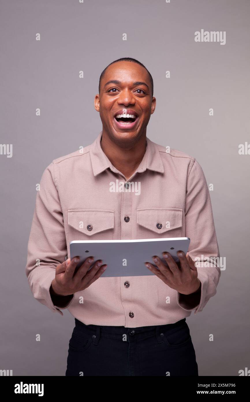 Man holding digital tablet and smiling Stock Photo