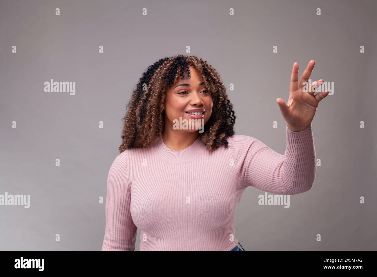 Smiling african woman making hi-res stock photography and images - Alamy