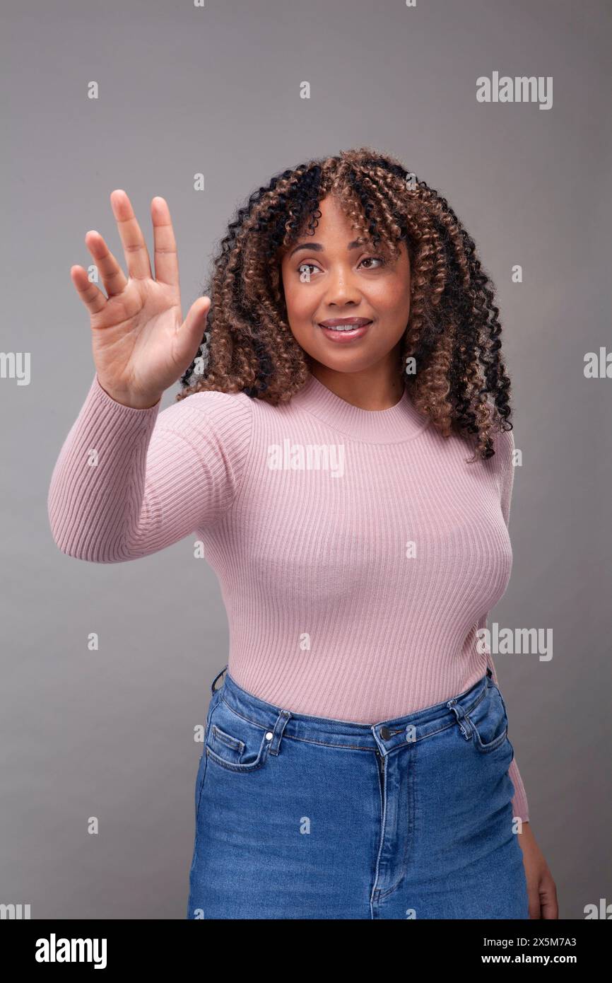 Smiling african woman making hi-res stock photography and images - Alamy