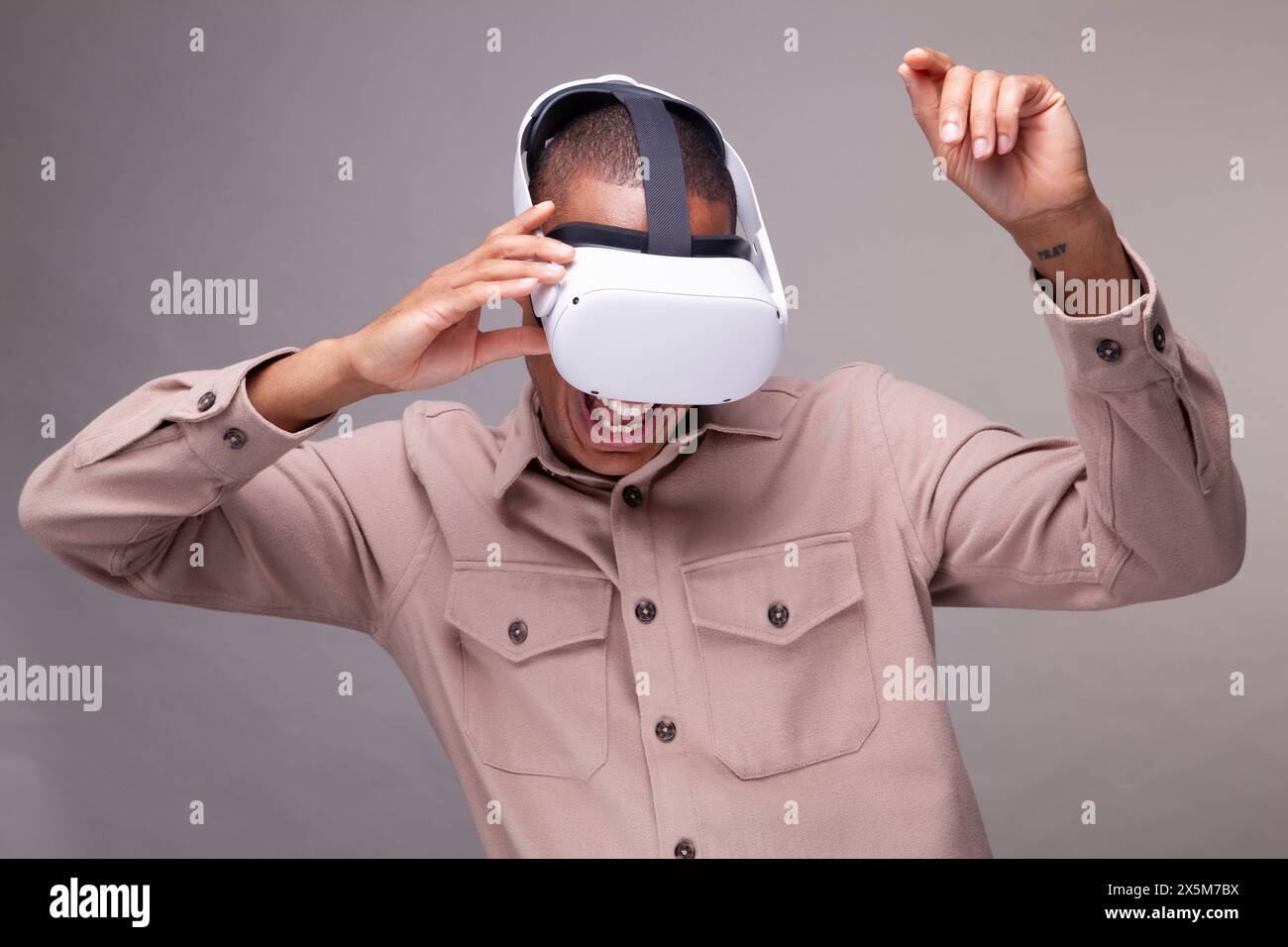 Man in virtual reality headset dancing Stock Photo
