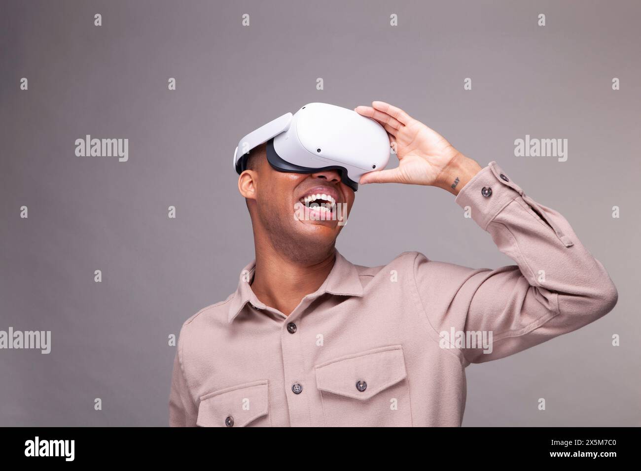 Smiling man in virtual reality headset Stock Photo