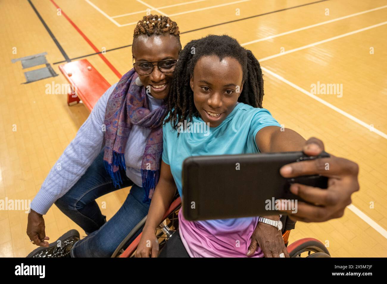 Teenage girl in wheelchair taking selfie with grandmother Stock Photo ...