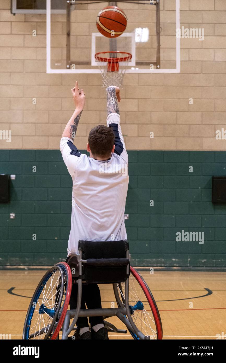 Male basketball player in wheelchair shooting ball Stock Photo Alamy