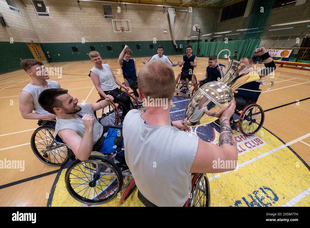 Team of basketball players in wheelchairs with trophy Stock Photo Alamy