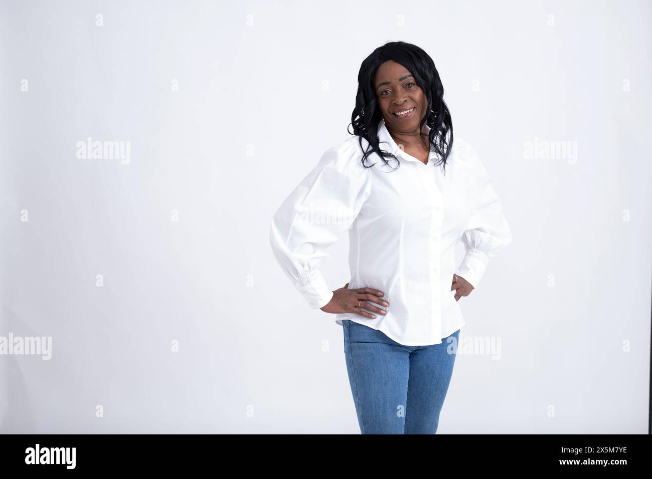 Studio portrait of mature woman wearing white shirt Stock Photo