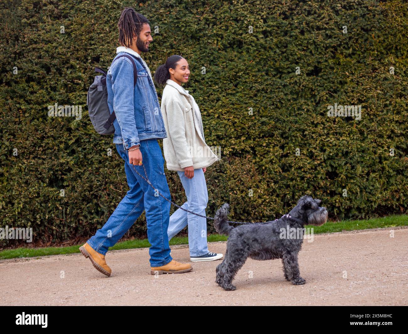 Couple walking in park with dog hi-res stock photography and images - Alamy