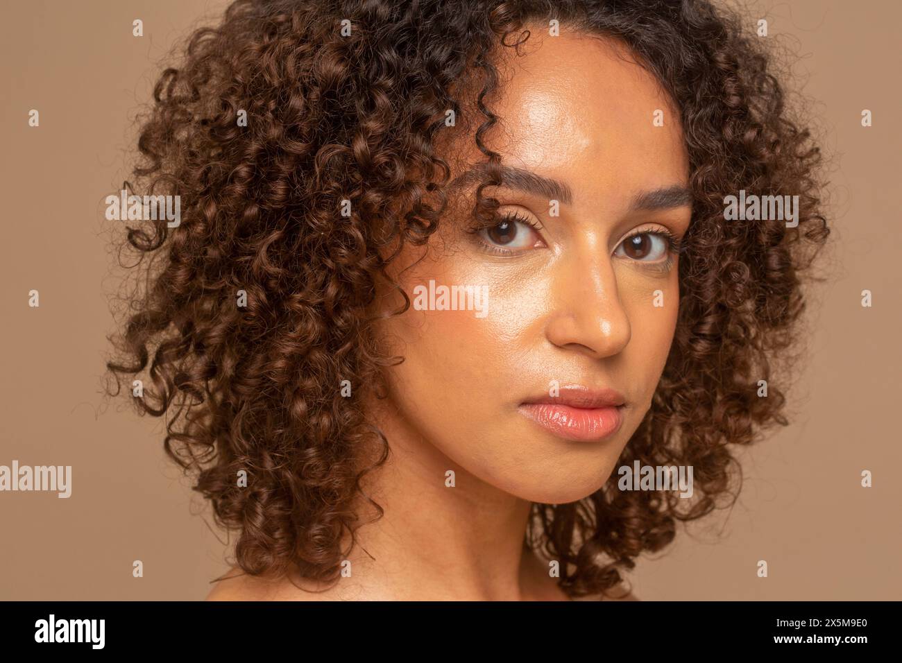 Studio portrait of woman with curly hair Stock Photo