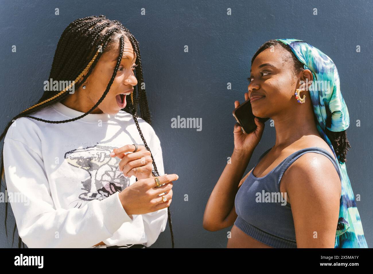 Two young women using smartphone Stock Photo
