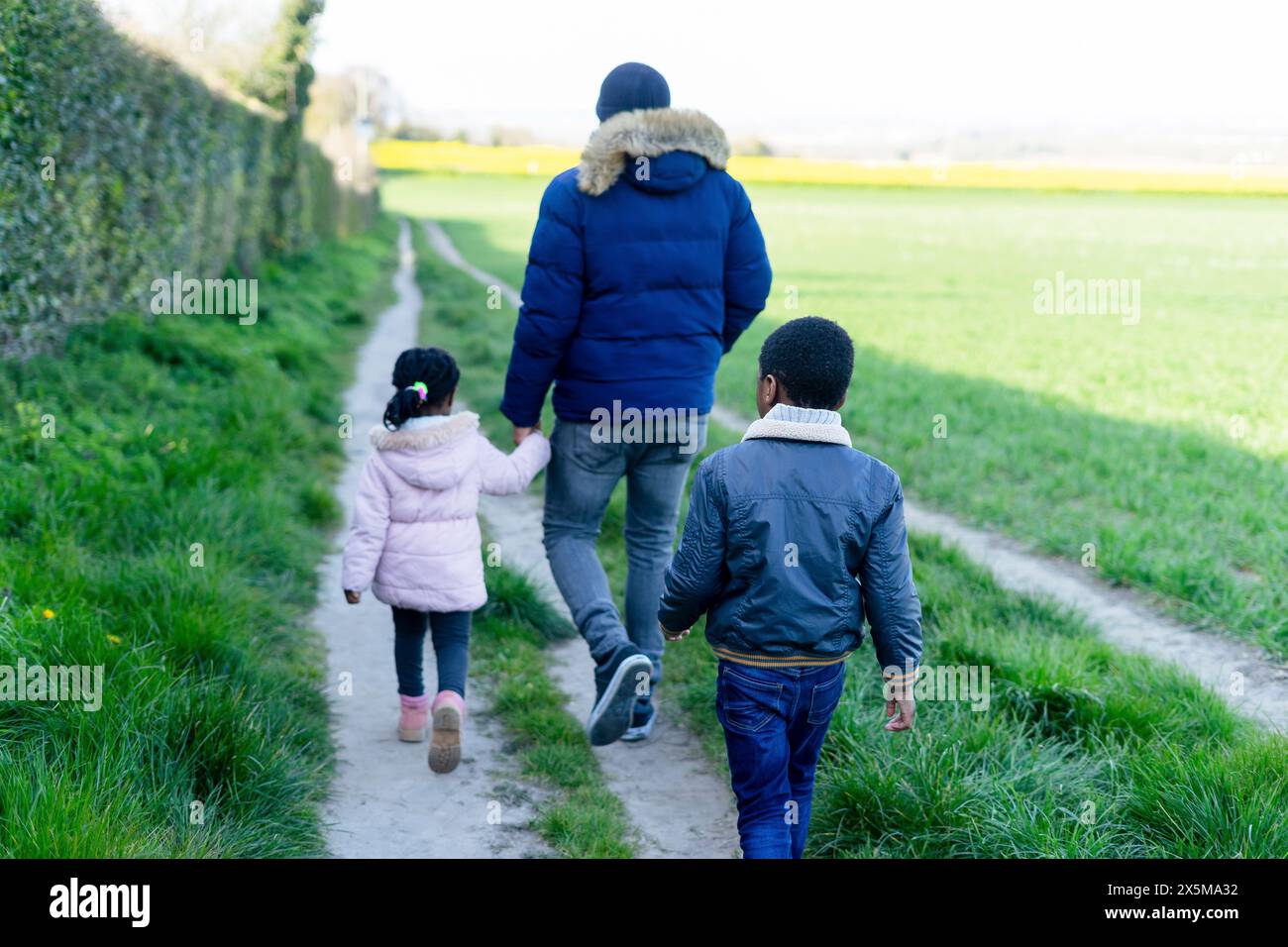 Father and children on walk in rural area Stock Photo