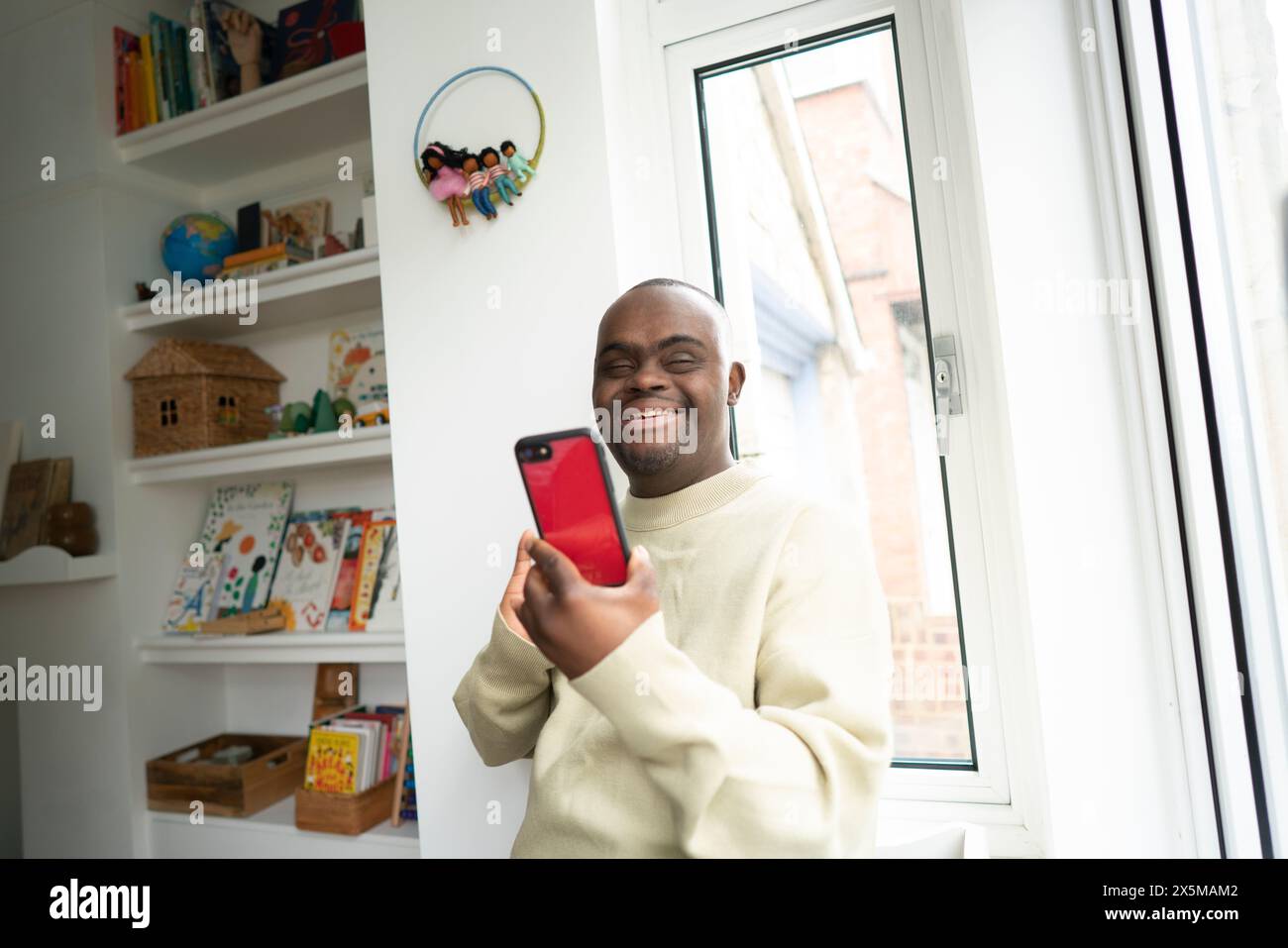 Man with Down syndrome using phone Stock Photo