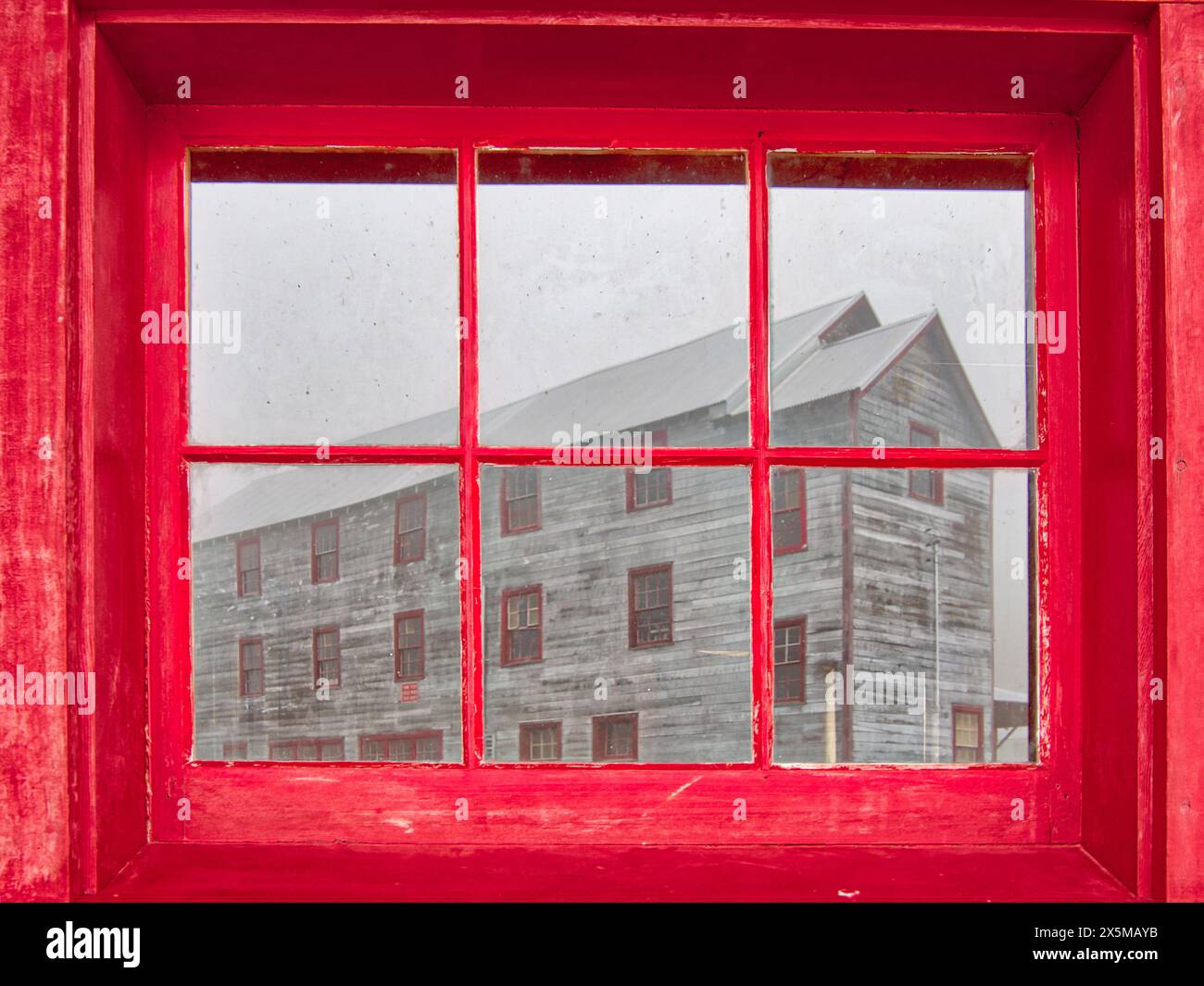 USA, Alaska. Window reflection of the No. 1 bunkhouse at the Independence Mine State Historical Park listed on the National Register of Historic Place Stock Photo
