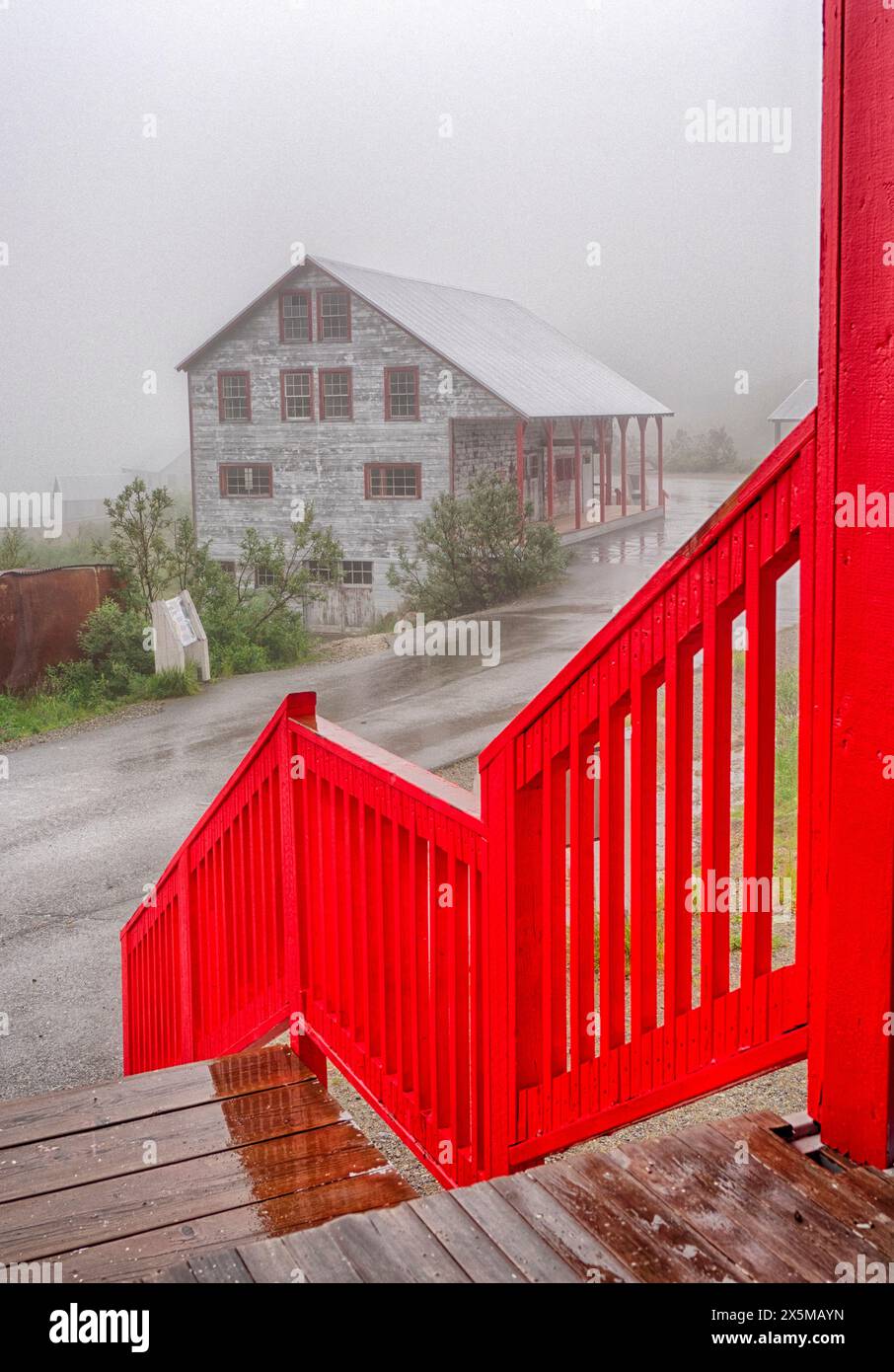 USA, Alaska. Bright red porch railing and the No.1 bunkhouse at the Independence Mine State Historical Park listed on the National Register of Histori Stock Photo