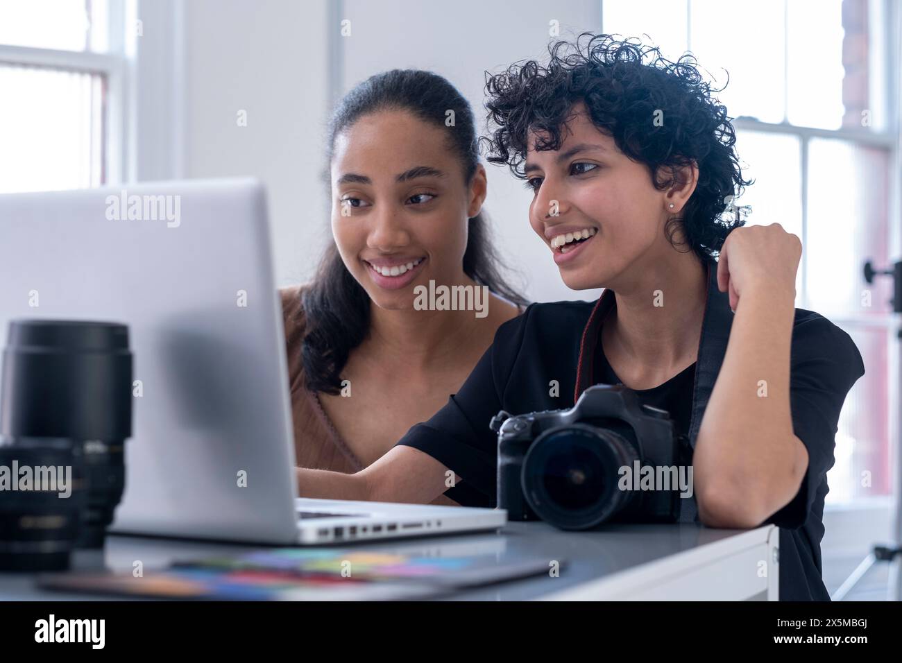 Female photographers using laptop Stock Photo
