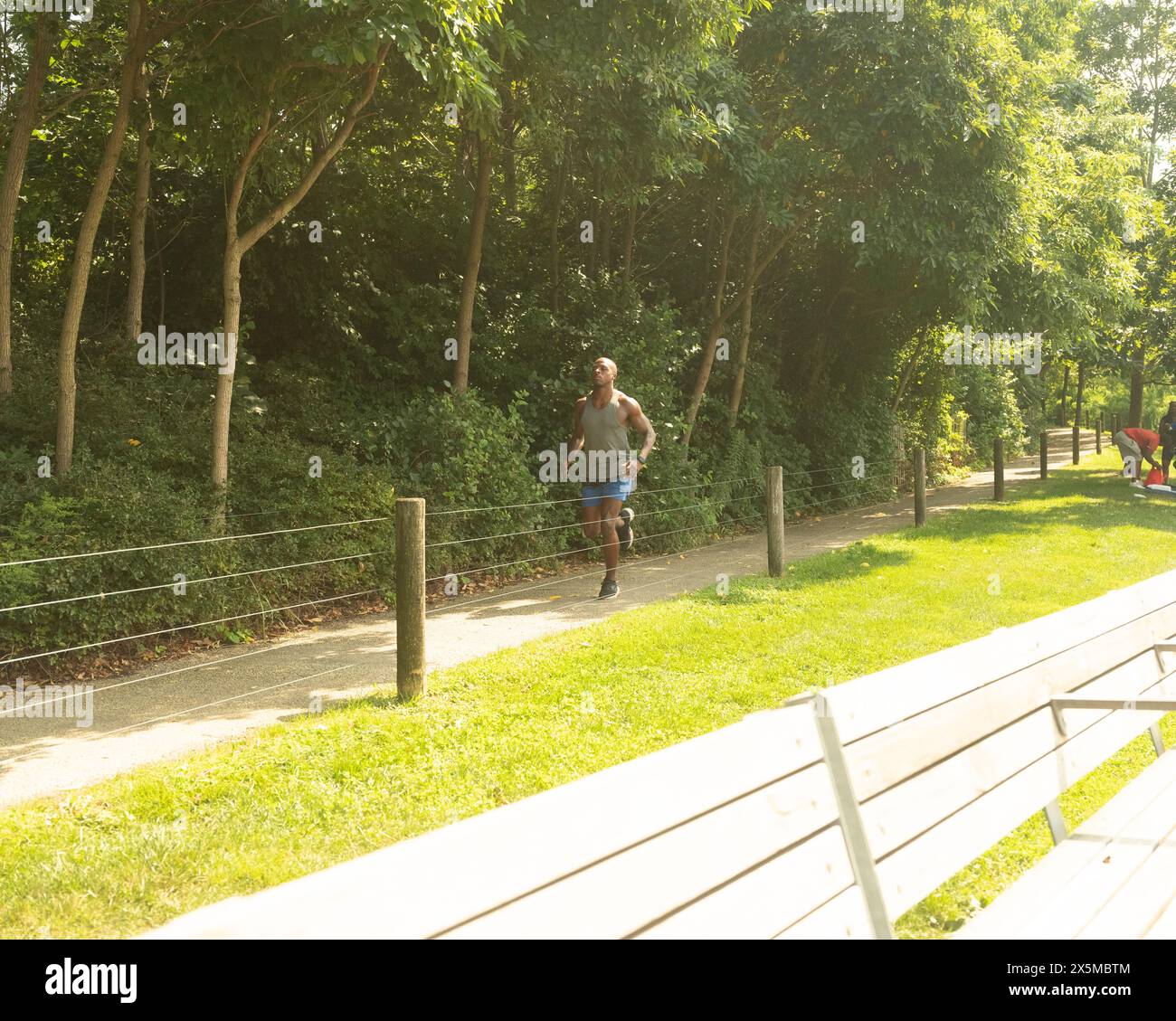 Athletic man jogging in park Stock Photo